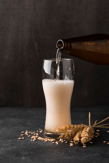 Beer bottle pouring beer in glass