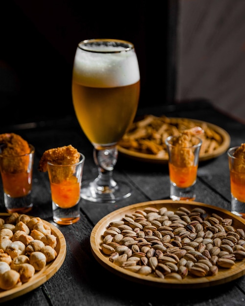 Beer served with beans and dried nuts on the table