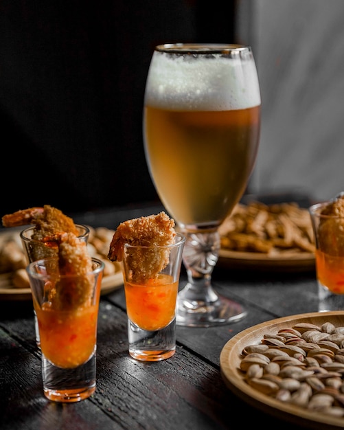 Beer with shrimps in barbecue sauce on the table