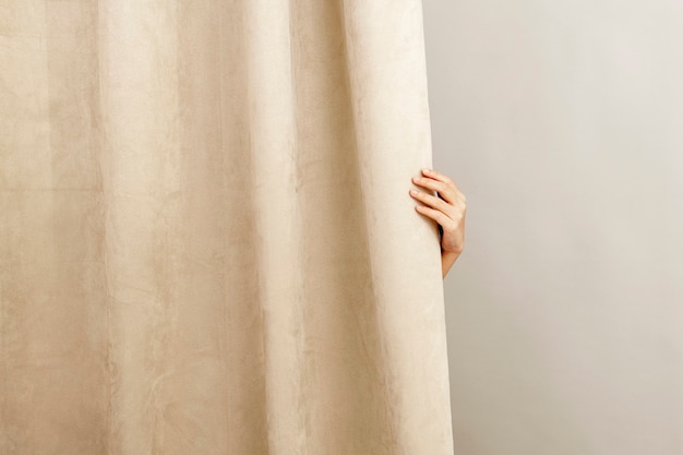 Free Photo beige curtain home decor, with female hand