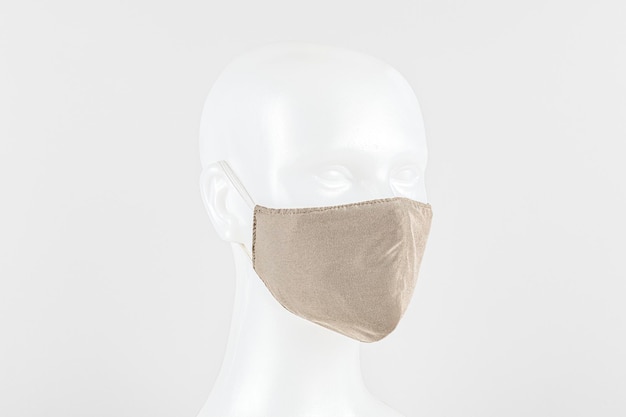 Free photo beige fabric face mask on a dummy head