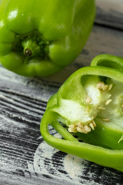 Free photo bell pepper green and sliced on wooden desk