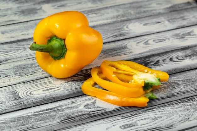 Bell pepper ripe fresh mellow sliced on grey wooden desk