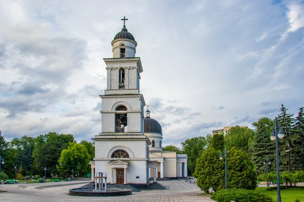 Free photo bell tower of the cathedral of christ's nativity surrounded by trees in chisinau, moldova