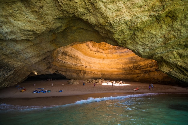 Free photo benagil cave boat tour inside algar de benagil, cave listed in the world's top 10 best caves. algarve coast near lagoa, portugal. tourists visit a popular landmark