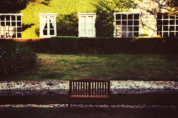 Free photo bench for relax in front of the green grass yard