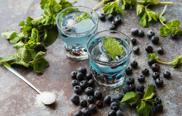 Berries and mint around refreshing blueberry drinks 