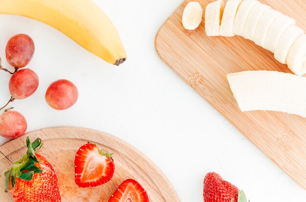 Berry fruits pieces on cut boards