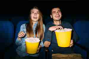 Free photo best date entertainment in cinema. young couple enjoying a movie at the cinema