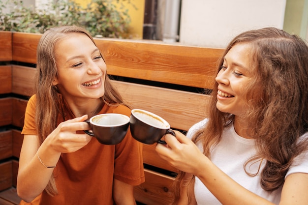 Free photo best friends drinking coffee together