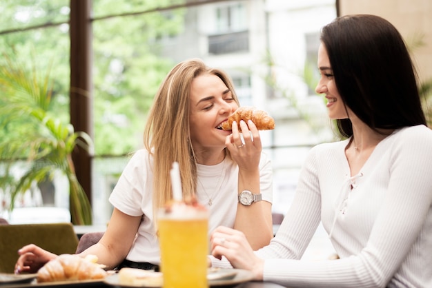 Best friends eating a croissant 