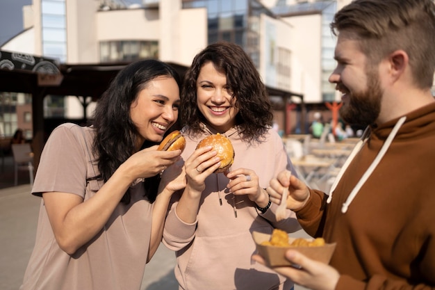 Free photo best friends eating street food