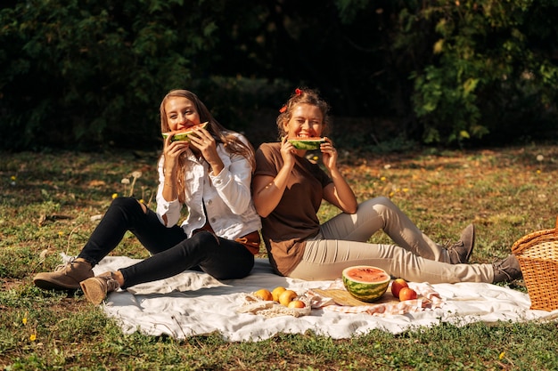 Free photo best friends eating watermelon