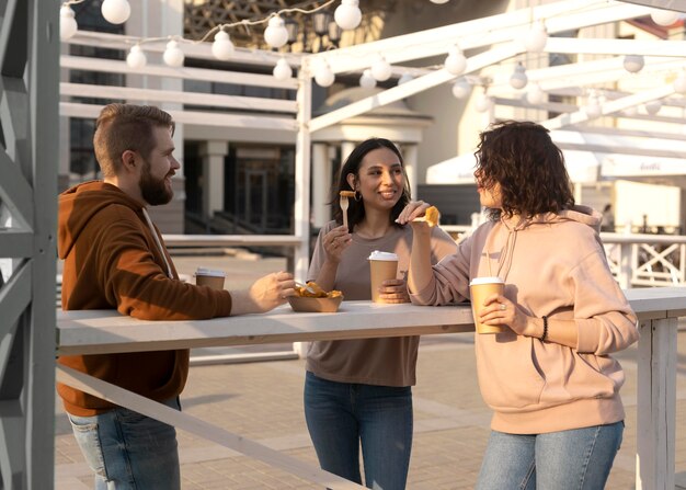 Best friends getting some street food outdoors