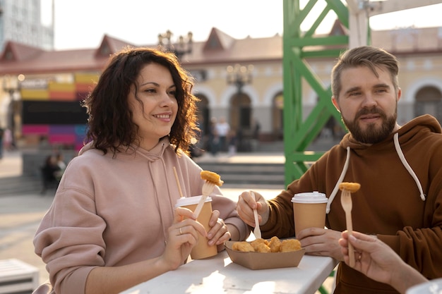 Free Photo best friends getting some street food outdoors