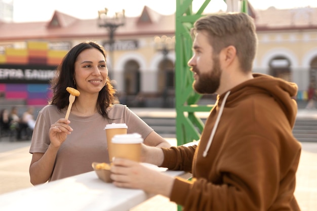 Best friends getting some street food outdoors