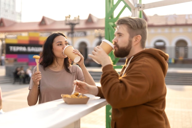 Best friends getting some street food outdoors