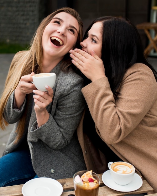 Best friends gossiping outside