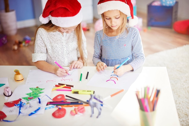 Free photo best friends making some christmas ornaments