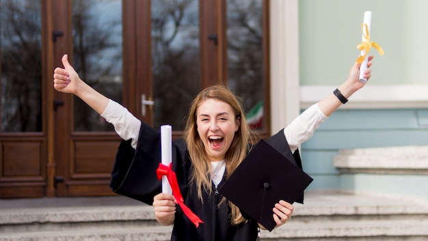 Free Photo best friends playing at graduation ceremony