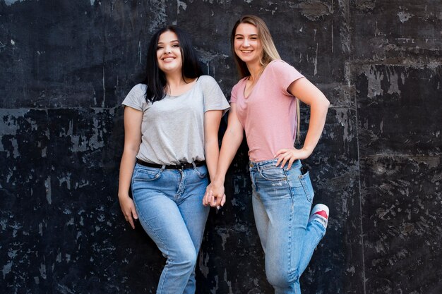 Best friends posing on a dark background