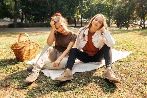 Best friends posing on a picnic blanket