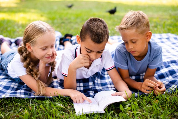 Best friends reading on a picnic blanket