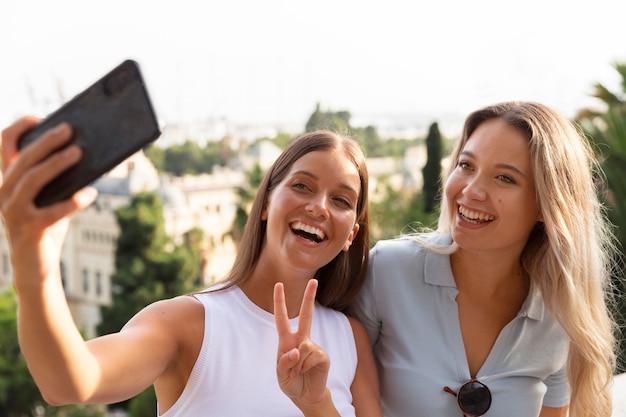 Free photo best friends taking a selfie together outdoors