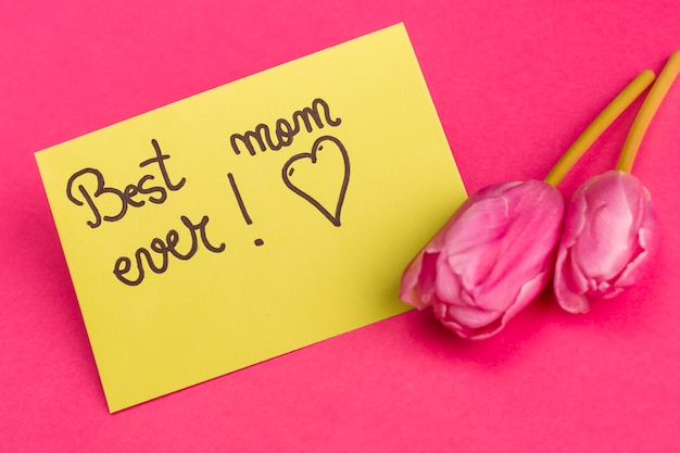 Best mom ever title on yellow paper near bright tulips