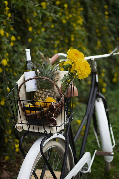 Free photo bicycle basket with beautiful flowers and bottle