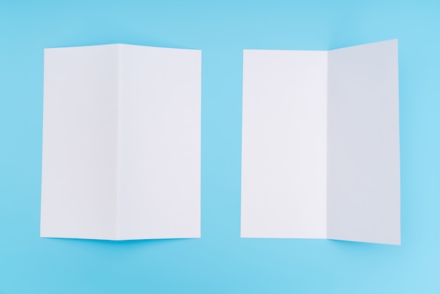 Free photo bifold white template paper on blue background .