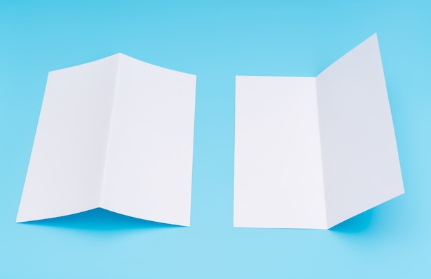 Free photo bifold white template paper on blue background .