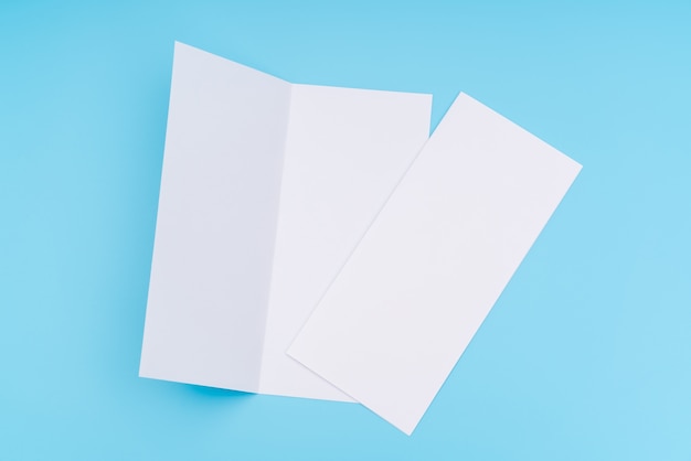 Free photo bifold white template paper on blue background .