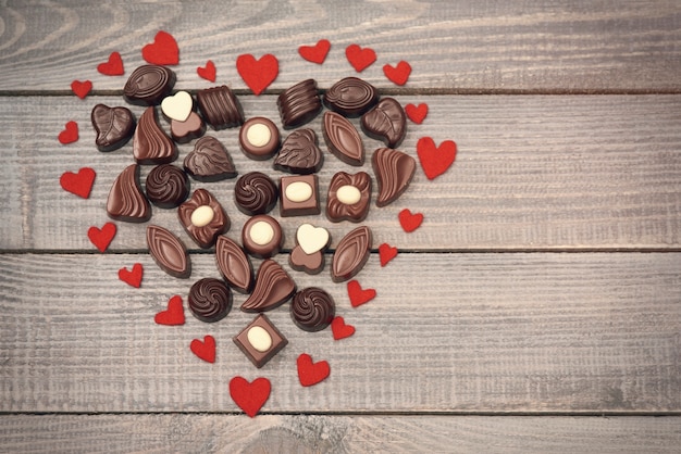 Free photo big heart full of chocolate candies