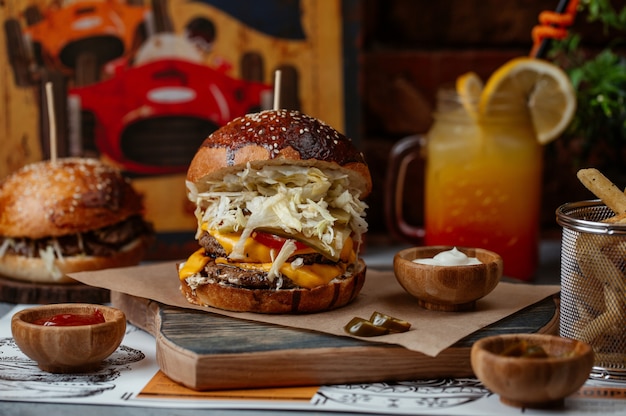 Big mac burger with beef, melted cheddar and full white salad