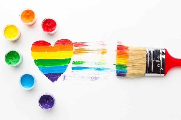 Free photo big paint brush and rainbow heart and tempera