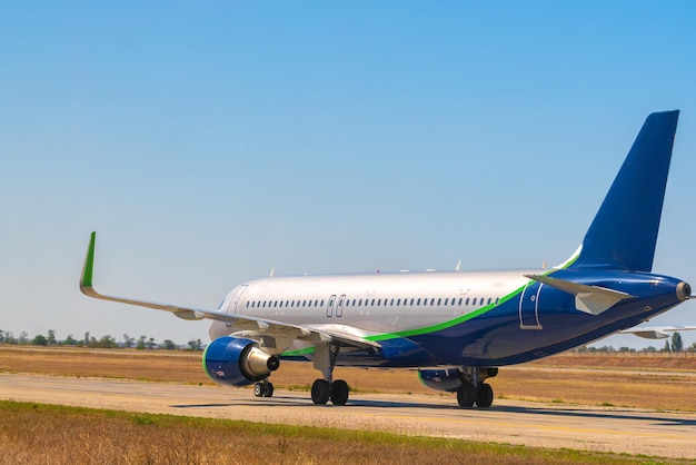 Free photo big passenger airplane drives along the runway in airport