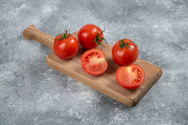 Big red fresh tomatoes on a marble background.