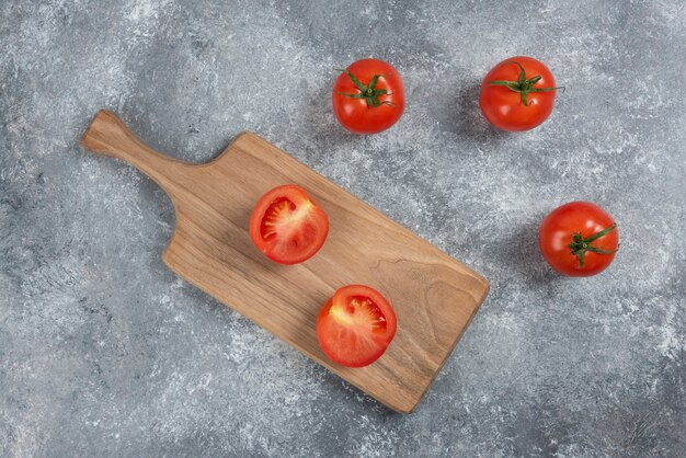 Big red fresh tomatoes on a marble background.