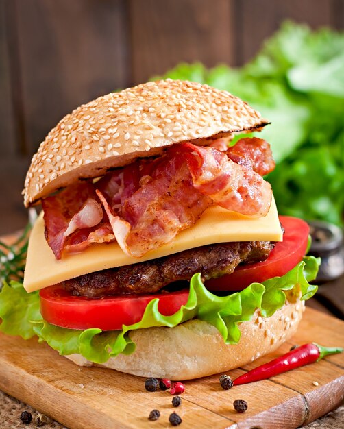 Big sandwich - hamburger burger with beef, cheese, tomato and fried bacon