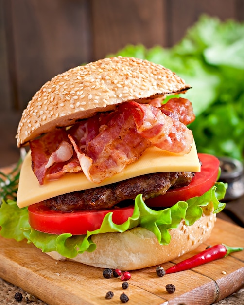 Big sandwich - hamburger burger with beef, cheese, tomato and fried bacon