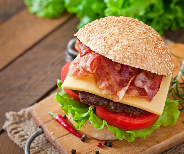 Big sandwich - hamburger burger with beef, cheese, tomato and fried bacon