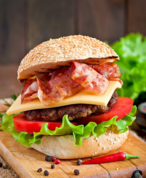 Big sandwich - hamburger burger with beef, cheese, tomato and fried bacon