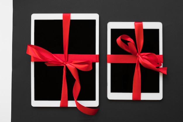 Free Photo big tablets with red ribbons