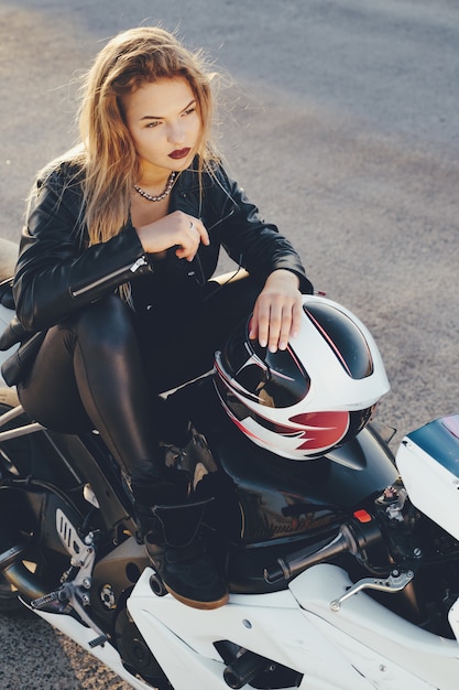 Biker girl in a leather clothes on a motorcycle