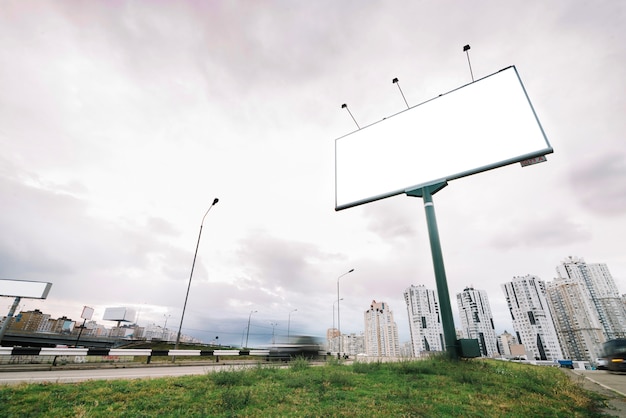 Free photo billboard on city entrance on cloudy day