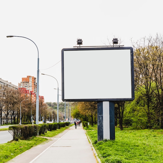 Billboard with two lamp near the sidewalk in the city