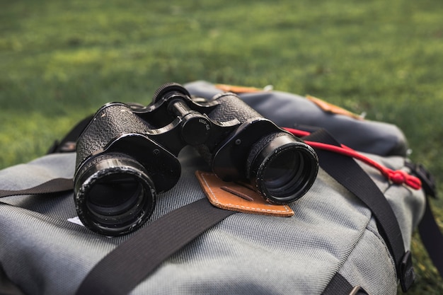 Free Photo binoculars lying on backpack