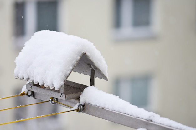 Free photo bird feeder in winter with snow.