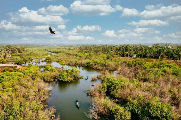 Bird's eye view of a wetland with people riding on boats and enjoying nature